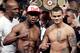 Floyd Mayweather Jr., left, poses on the scales with Marcos Maidana during the official weigh-in at the MGM Grand Hotel in Las Vegas, Friday, May 2, 2014. Mayweather is to face Maidana in a welterweight title fight on Saturday. (AP Photo/Chris Carlson)