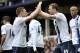 Manchester City's Edin Dzeko, right, celebrates with teammate James Milner after scoring the second goal of the game during their English Premier League soccer match against Everton at Goodison Park in Liverpool, England, Saturday May 3, 2014. (AP Photo/Clint Hughes)