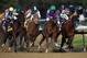 Victor Espinoza rides California Chrome around turn four to a victory during the 140th running of the Kentucky Derby horse race at Churchill Downs Saturday, May 3, 2014, in Louisville, Ky. (AP Photo/Matt Slocum)