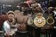 Floyd Mayweather Jr., center, poses with his corner and a champion's belt after his WBC-WBA welterweight title boxing fight against Marcos Maidana Saturday, May 3, 2014, in Las Vegas. Mayweather won the bout by majority decision. (AP Photo/Isaac Brekken)