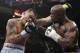 Marcos Maidana, left, from Argentina, trades blows with Floyd Mayweather Jr. in their WBC-WBA welterweight title boxing fight Saturday, May 3, 2014, in Las Vegas. Mayweather won the bout by majority decision. (AP Photo/Isaac Brekken)