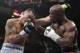 Marcos Maidana, left, from Argentina, trades blows with Floyd Mayweather Jr. in their WBC-WBA welterweight title boxing fight Saturday, May 3, 2014, in Las Vegas. Mayweather won the bout by majority decision. (AP Photo/Isaac Brekken)