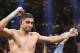 England's Amir Khan celebrates his unanimous decision over Luis Collazo in their silver welterweight title boxing fight Saturday, May 3, 2014, in Las Vegas. (AP Photo/Eric Jamison)