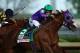 LOUISVILLE, KY - MAY 03: California Chrome #5, ridden by Victor Espinoza, pulls away from Chitu #13, ridden by Martin Garcia, coming out of the fourth turn enroute to winning the 140th running of the Kentucky Derby at Churchill Downs on May 3, 2014 in Louisville, Kentucky. (Photo by Andy Lyons/Getty Images)
