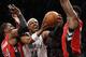 Toronto Raptors forward Patrick Patterson (54) and Raptors forward Amir Johnson (15) defend Brooklyn Nets forward Paul Pierce (34) as pierce goes up for a layup in the second half of Game 4 of an NBA basketball first-round playoff series at the Barclays Center, Sunday, April 27, 2014, in New York. The Raptors evened the series at 2-2 defeating the Nets 87-79. (AP Photo/Kathy Willens)