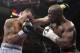 Marcos Maidana, left, from Argentina, trades blows with Floyd Mayweather Jr. in their WBC-WBA welterweight title boxing fight Saturday, May 3, 2014, in Las Vegas. Mayweather won the bout by majority decision. (AP Photo/Isaac Brekken)