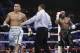 Marcos Maidana, left, is sent to his corner by referee Tony Weeks, center, after accidentally head butting Floyd Mayweather Jr. in their WBC-WBA welterweight title boxing fight Saturday, May 3, 2014, in Las Vegas. (AP Photo/Isaac Brekken)