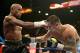 LAS VEGAS, NV - MAY 03: (L-R) Floyd Mayweather Jr. and Marcos Maidana exchange blows during their WBC/WBA welterweight unification fight at the MGM Grand Garden Arena on May 3, 2014 in Las Vegas, Nevada. Mayweather took Maidana's title with a majority-decision victory. (Photo by Harry How/Getty Images)