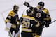 Boston Bruins goalie Tuukka Rask (40) is congratulated by teammates Dougie Hamilton (27) and Daniel Paille (20) after beating the Montreal Canadiens during Game 2 in the second-round of the Stanley Cup hockey playoff series in Boston, Saturday, May 3, 2014. The Bruins defeated the Canadiens 5-3, tying the series at one game each. (AP Photo/Charles Krupa)