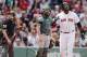 Boston Red Sox's David Ortiz, right, flips his bat in front of Oakland Athletics' Derek Norris after hitting a solo home run in the third inning of a baseball game in Boston, Saturday, May 3, 2014. (AP Photo/Michael Dwyer)