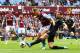 Edin Dzeko tussles for the ball at Villa Park.