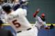 Cincinnati Reds starting pitcher Johnny Cueto, right, throws to Atlanta Braves' Freddie Freeman in the first inning of a baseball game, Sunday, April 27, 2014, in Atlanta. (AP Photo/David Goldman)