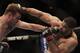 Dan Miller of the U.S, left, and Brazil's Rousimar Palhares exchange punches during their middleweight mixed martial arts bout at the Ultimate Fighting Championship (UFC) 134 in Rio de Janeiro, Brazil, Saturday Aug. 27, 2011. (AP Photo/Felipe Dana)