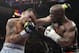 Marcos Maidana, left, from Argentina, trades blows with Floyd Mayweather Jr. in their WBC-WBA welterweight title boxing fight Saturday, May 3, 2014, in Las Vegas. Mayweather won the bout by majority decision. (AP Photo/Isaac Brekken)