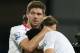 Liverpool's Steven Gerrard, left, reacts with teammate Luis Suarez, following the end of the English Premier League soccer match between Crystal Palace and Liverpool at Selhurst Park stadium in London, Monday, May 5, 2014. The game ended in a 3-3 draw. (AP Photo/Alastair Grant)