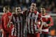 Atletico's Koke, left and teammate Atletico's Diego Godin celebrate in front of their fans after defeating Chelsea in the Champions League semifinal second leg soccer match between Chelsea and Atletico Madrid at Stamford Bridge stadium in London, Wednesday, April 30, 2014. (AP Photo/Matt Dunham)