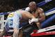 Floyd Mayweather Jr., right, is driven through the ropes by Marcos Maidana in their WBC-WBA welterweight title boxing fight Saturday, May 3, 2014, in Las Vegas. Mayweather won the bout by majority decision. (AP Photo/Eric Jamison)