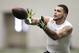 Texas A&M wide receiver Mike Evans catches a pass from quarterback Johnny Manziel during a drill at pro day for NFL football representatives in College Station, Texas, Thursday, March 27, 2014. (AP Photo/Patric Schneider)