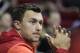 Texas A&M quarterback Johnny Manziel watches as the Houston Rockets take on the Minnesota Timberwolves during an NBA basketball game , Thursday, March 20, 2014, in Houston. (AP Photo/Patric Schneider)