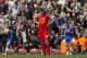 Liverpool's Steven Gerrard watches as Chelsea celebrate their second goal during their English Premier League soccer match at Anfield Stadium, Liverpool, England, Sunday April 27, 2014. Chelsea won the game 2-0. (AP Photo/Jon Super)