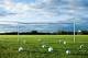 Footballs on empty pitch (Image Source via AP Images)