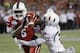 Miami defensive back Deon Bush (2) sacks Louisville quarterback Teddy Bridgewater (5) in the end zone for a safety during the first half of the Russell Athletic Bowl NCAA college football game in Orlando, Fla., Saturday, Dec. 28, 2013. (AP Photo/John Raoux)