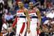 Washington Wizards guard Bradley Beal (3) and Washington Wizards guard John Wall (2) smile in the second half of an NBA basketball game against the Portland Trail Blazers, Monday, Feb. 3, 2014, in Washington. The Wizards won 100-90. (AP Photo/Alex Brandon)