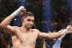 England's Amir Khan celebrates his unanimous decision over Luis Collazo in their silver welterweight title boxing fight Saturday, May 3, 2014, in Las Vegas. (AP Photo/Eric Jamison)