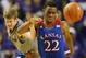 Kansas guard Andrew Wiggins (22) and Kansas State guard Will Spradling, left, chase the ball during the second half of an NCAA college basketball game in Manhattan, Kan., Monday, Feb. 10, 2014. Kansas State defeated Kansas 85-82 in overtime. (AP Photo/Orlin Wagner)
