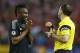 Chelsea's Jon Obi Mikel reacts as he gets a yellow card from referee Jonas Eriksson during the Champions League semifinal first leg soccer match between Atletico Madrid and Chelsea at the Vicente Calderon stadium in Madrid, Spain, Tuesday, April 22, 2014. (AP Photo/Andres Kudacki)