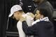 Former Texas A&M football quarterback Johnny Manziel, left and entertainer, Drake leave the floor during halftime of the NCAA Final Four tournament college basketball semifinal game between Wisconsin and Kentucky Saturday, April 5, 2014, in Arlington, Texas. (AP Photo/David J. Phillip)