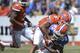 Florida wide receiver Chris Thompson (85) muscles his way across the goal line for a touchdown as he is hit by Orange player Jalen Tabor (5) during the Orange & Blue Debut in Gainesville, Fla. Saturday, April 12, 2014. (AP Photo/Phil Sandlin)