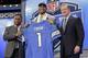 North Carolina tight end Eric Ebron, center, poses for photos with former NFL player Barry Sanders, left, and NFL commissioner Roger Goodell after being chosen by the Detroit Lions as the 10th pick in the first round of the 2014 NFL Draft, Thursday, May 8, 2014, in New York. (AP Photo/Craig Ruttle)