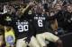Colorado defensive lineman De'Jon Wilson, left, joins wide receiver Paul Richardson in singing the school song with fans after their 41-24 victory over California in an NCAA football game in Boulder, Colo., Saturday, Nov. 16, 2013. (AP Photo/David Zalubowski)