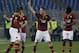 AS Roma's Francesco Totti, center, celebrates with teammates after scoring during a Serie A soccer match between AS Roma and Udinese in Rome's Olympic stadium, Monday, March 17, 2014. (AP Photo/Gregorio Borgia)