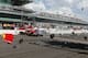Sebastian Saavedra, left, of Colombia, is hit by Mikhail Aleshin, of Russia, at the start of the inaugural Grand Prix of Indianapolis IndyCar auto race at the Indianapolis Motor Speedway in Indianapolis, Saturday, May 10, 2014. (AP Photo/Robert Baker)