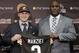 El nuevo quarterback de los Cleveland Browns, Johnny Manziel, de Texas A&M, sostiene su nuevo jersey al lado del gerente general del equipo, Ray Farmer en las instalaciones de entrenamiento del equipo durante la conferencia de prensa del viernes 9 de mayo de 2014 en Berea, Ohio. (FOTO AP/Tony Dejak)