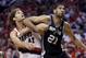 Portland Trail Blazers' Robin Lopez (42) and San Antonio Spurs' Tim Duncan (21) battle for position under the boards in the second quarter during Game 3 of a Western Conference semifinal NBA basketball playoff series Saturday, May 10, 2014, in Portland, Ore. (AP Photo/Rick Bowmer)