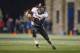 Northern Illinois quarterback Jordan Lynch (6) runs the ball against Toledo during the second quarter of an NCAA college football game in Toledo, Ohio, Wednesday, Nov. 20, 2013. (AP Photo/Rick Osentoski)