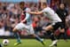 Aston Villa's Andreas Weimann, left, tries to get away from Tottenham Hotspur's Michael Dawson, who fouled and received a yellow card for the tackle during their English Premier League soccer match at Villa Park stadium in Birmingham, England, Sunday, Oct. 20, 2013. (AP Photo/Alastair Grant)