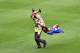 GENOA, ITALY - MAY 11: A fan of Sampdoria is carried off by a steward after running onto the pitch during the Serie A match between UC Sampdoria and SSC Napoli at Stadio Luigi Ferraris on May 11, 2014 in Genoa, Italy. (Photo by Tullio M. Puglia/Getty Images)