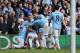 Manchester City players celebrate with their teammate Vincent Kompany, obscured, after he scored their second goal during the English Premier League soccer match between Manchester City and West Ham at the Etihad Stadium in Manchester, England, Sunday May 11, 2014. (AP Photo/Jon Super)