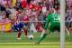 MADRID, SPAIN - MAY 11: David Villa (L) of Atletico de Madrid strikes the ball against goalkeeper Willy Caballero (R) of Malaga CF during the La Liga match between Club Atletico de Madrid and Malaga CF at Vicente Calderon Stadium on May 11, 2014 in Madrid, Spain. (Photo by Gonzalo Arroyo Moreno/Getty Images)