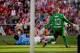 MADRID, SPAIN - MAY 11: David Villa (2ndL) of Atletico de Madrid strikes the ball against goalkeeper Willy Caballero (R) of Malaga CF and his teammate Weligton Robson (L) during the La Liga match between Club Atletico de Madrid and Malaga CF at Vicente Calderon Stadium on May 11, 2014 in Madrid, Spain. (Photo by Gonzalo Arroyo Moreno/Getty Images)