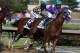 May 3, 2014; Louisville, KY, USA; Victor Espinoza aboard California Chrome (5) passes Martin Garcia aboard Chitu (13) during the 2014 Kentucky Derby at Churchill Downs. Mandatory Credit: Brian Spurlock-USA TODAY Sports