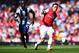 LONDON, ENGLAND - MAY 04: Mesut Ozil (R) of Arsenal controls the ball ahead of Youssuf Mulumbu (L) of West Bromwich Albion during the Barclays Premier League match between Arsenal and West Bromwich Albion at the Emirates Stadium on May 4, 2014 in London, England. (Photo by Shaun Botterill/Getty Images)