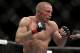 Georges St. Pierre, of Canada, fights Johny Hendricks during a UFC 167 mixed martial arts championship welterweight bout on Saturday, Nov. 16, 2013, in Las Vegas. St. Pierre won by split decision. (AP Photo/Isaac Brekken)