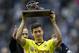 Dortmund's Robert Lewandowski of Poland lifts the goal-getter trophy after the German Bundesliga soccer match between Hertha BSC Berlin and Borussia Dortmund in in Berlin, Germany, Saturday, May 10, 2014. (AP Photo/Michael Sohn)