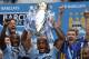 Manchester City's Vincent Kompany raises the trophy after the English Premier League soccer match between Manchester City and West Ham at the Etihad Stadium in Manchester, England, Sunday May 11, 2014. Manchester City won the Premier League for the second time in three seasons on Sunday, completing its campaign with a comfortable 2-0 victory over West Ham that lacked any of the drama of its previous title. (AP Photo/Jon Super)