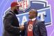 Virginia tackle Morgan Moses greets former Washington Redskins' linebacker London Fletcher after being selected by the Redskins as the 66th pick during the third round of the 2014 NFL Draft, Friday, May 9, 2014, in New York. (AP Photo/Jason DeCrow)